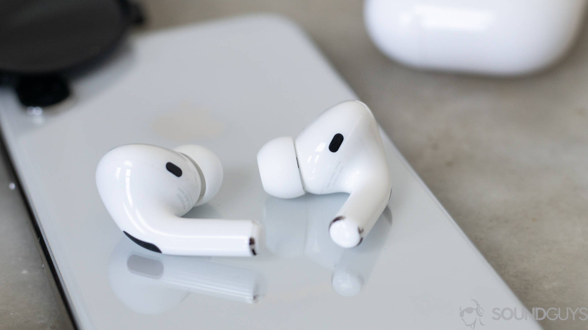The Apple AirPods Pro noise canceling true wireless earbuds rest on a smartphone.