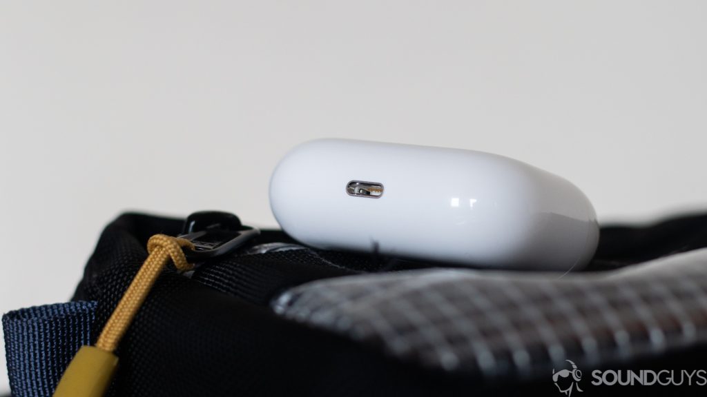 The charging case on top of a bag with the lightning connector port visible. 
