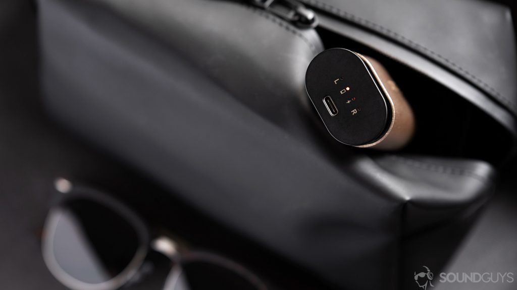 An image of the Creative Outlier Air charging case emerging from a black dop kit.