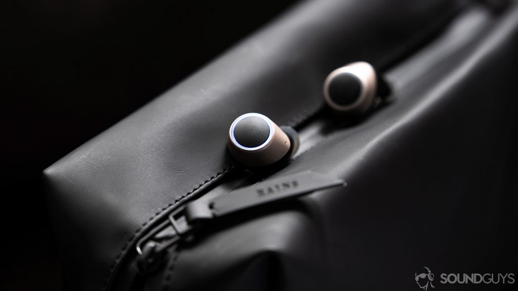An image of the Creative Outlier Air earbuds in champagne gold on a black waterproof bag.
