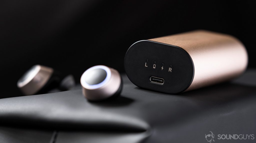 An image of the Creative Outlier Gold best true wireless earbuds in front of the charging case with the USB-C input in focus.