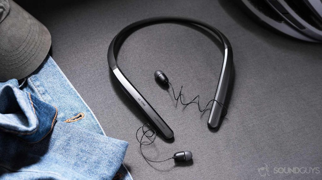 The LG Tone Flex XL7 in full view between a denim jacket and grey bike helmet.