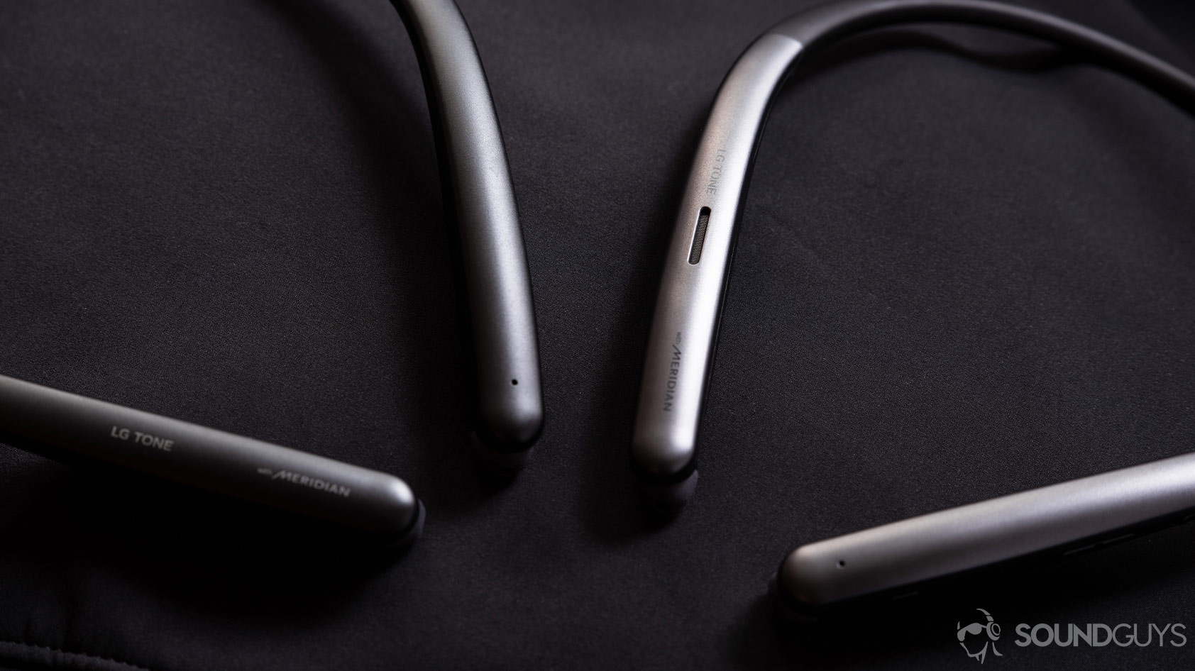 LG Tone Style SL6s and SL5 neckband wireless earbuds next to each other and angled on a black surface.