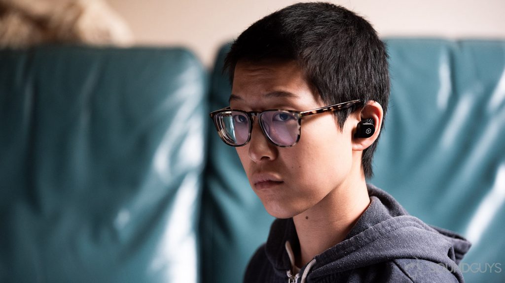 An image of a woman wearing the Master & Dynamic MW07 Go true wireless earbuds.