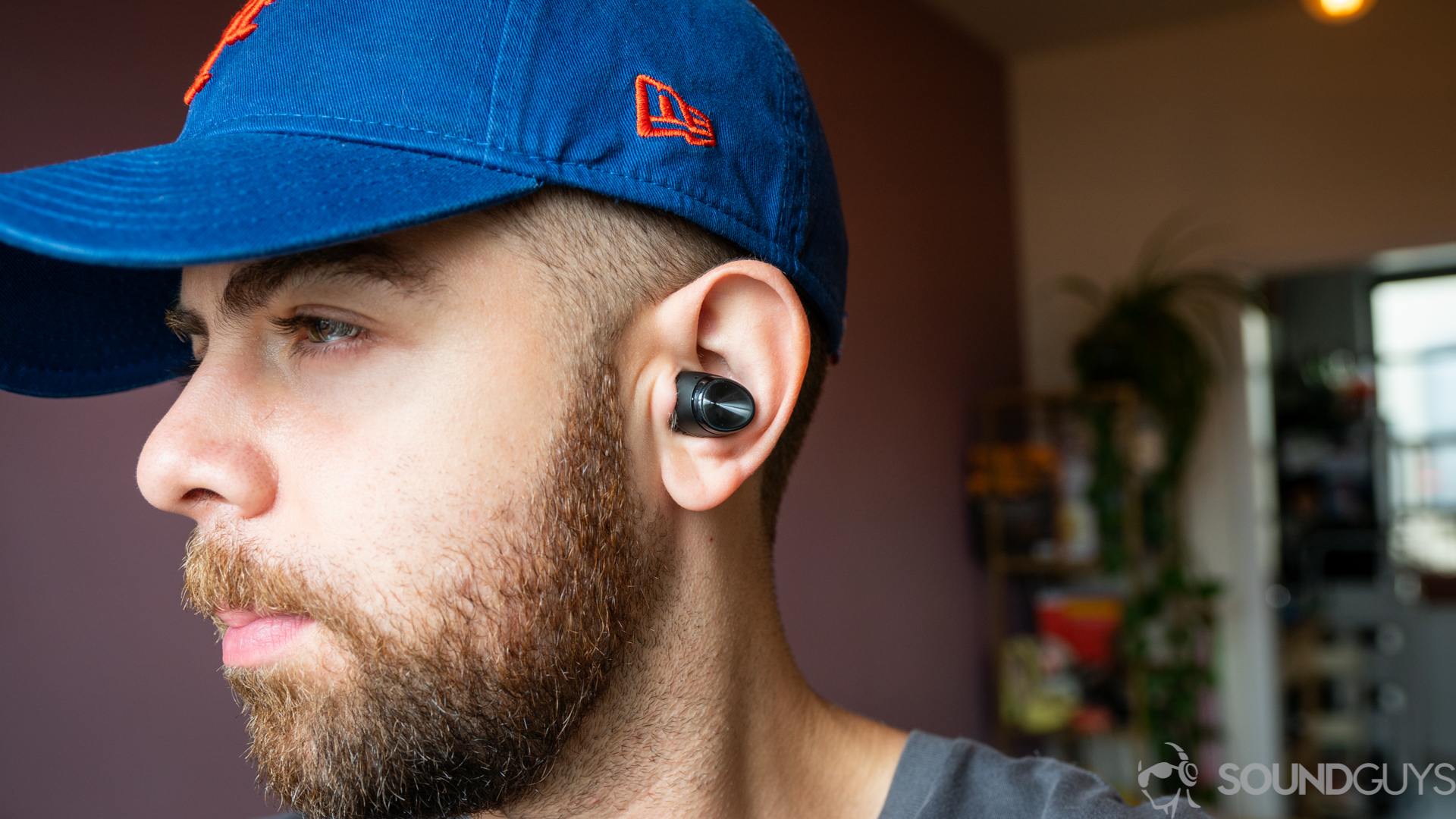 Man wearing Optoma Be Free6 true wireless earbuds
