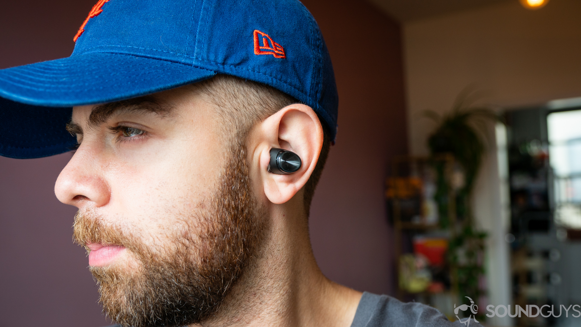 Man wearing Optoma Be Free6 true wireless earbuds Man wearing Optoma Be Free6 true wireless earbuds