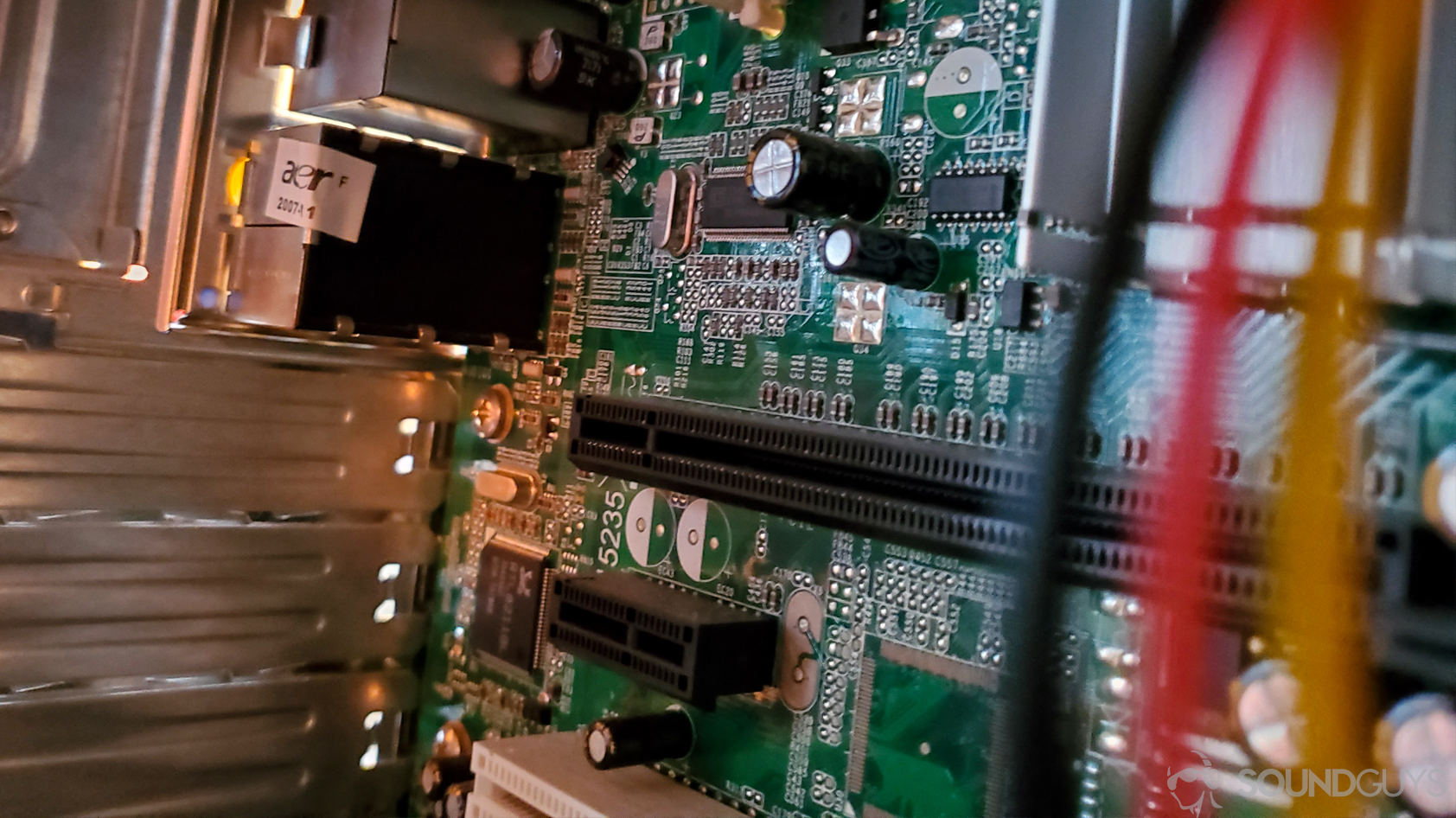 A photo of the inside of a computer, showing both the PCI and PCIe card slots for inserting sound card