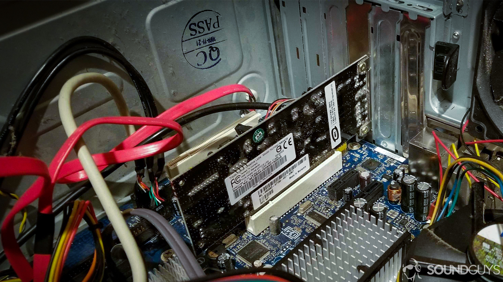 soundcard-in-computer A photo of a soundcard installed in a PCI slot inside a dusty computer tower.