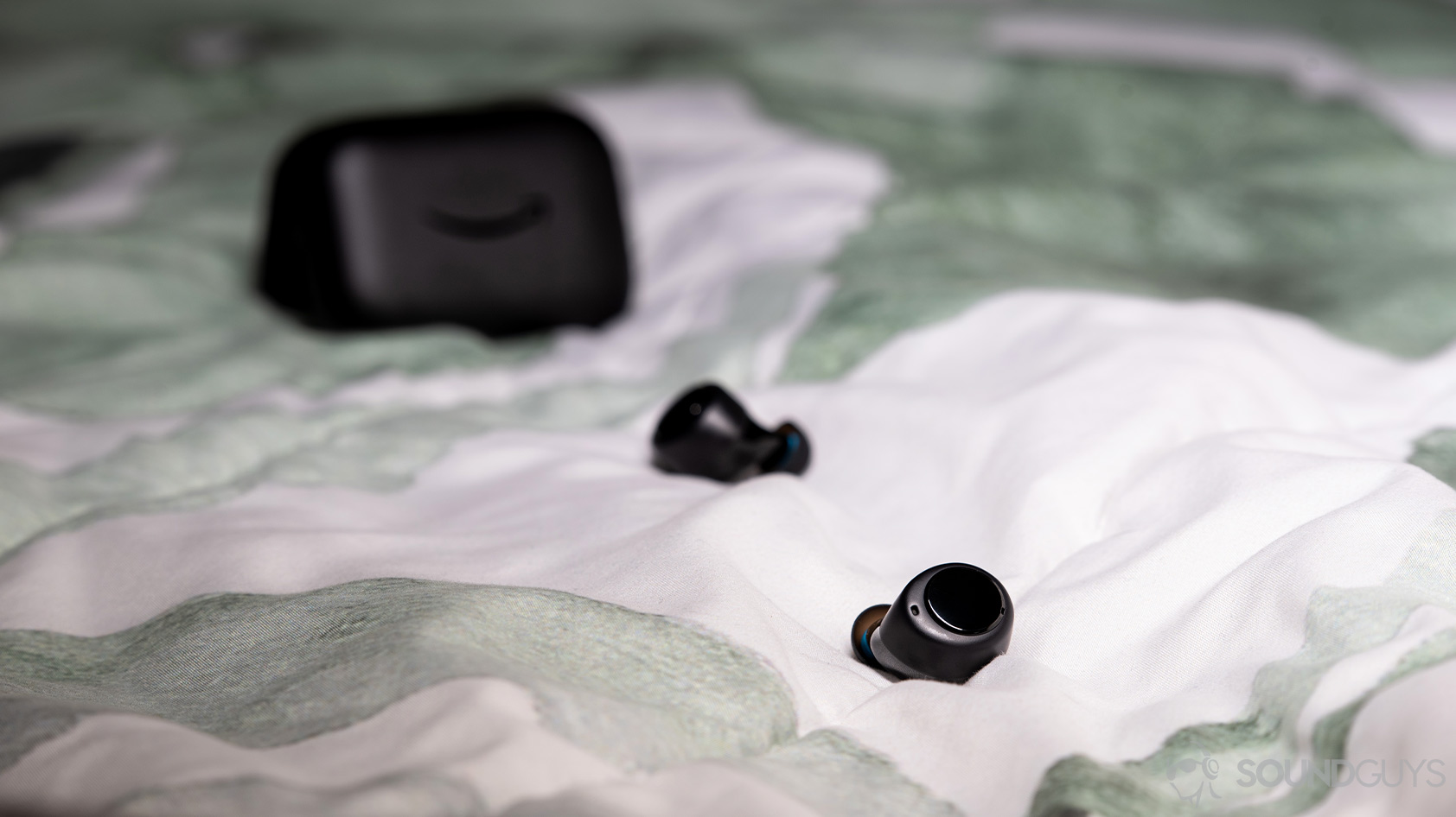 A picture of the Amazon Echo Buds true wireless earbuds outside of the charging case.