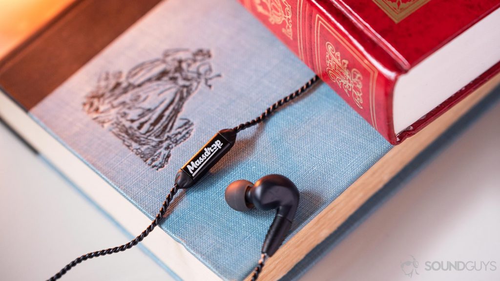 A photo of the Massdrop x MEE audio Pinnacle PX integrated microphone next to the earbud.