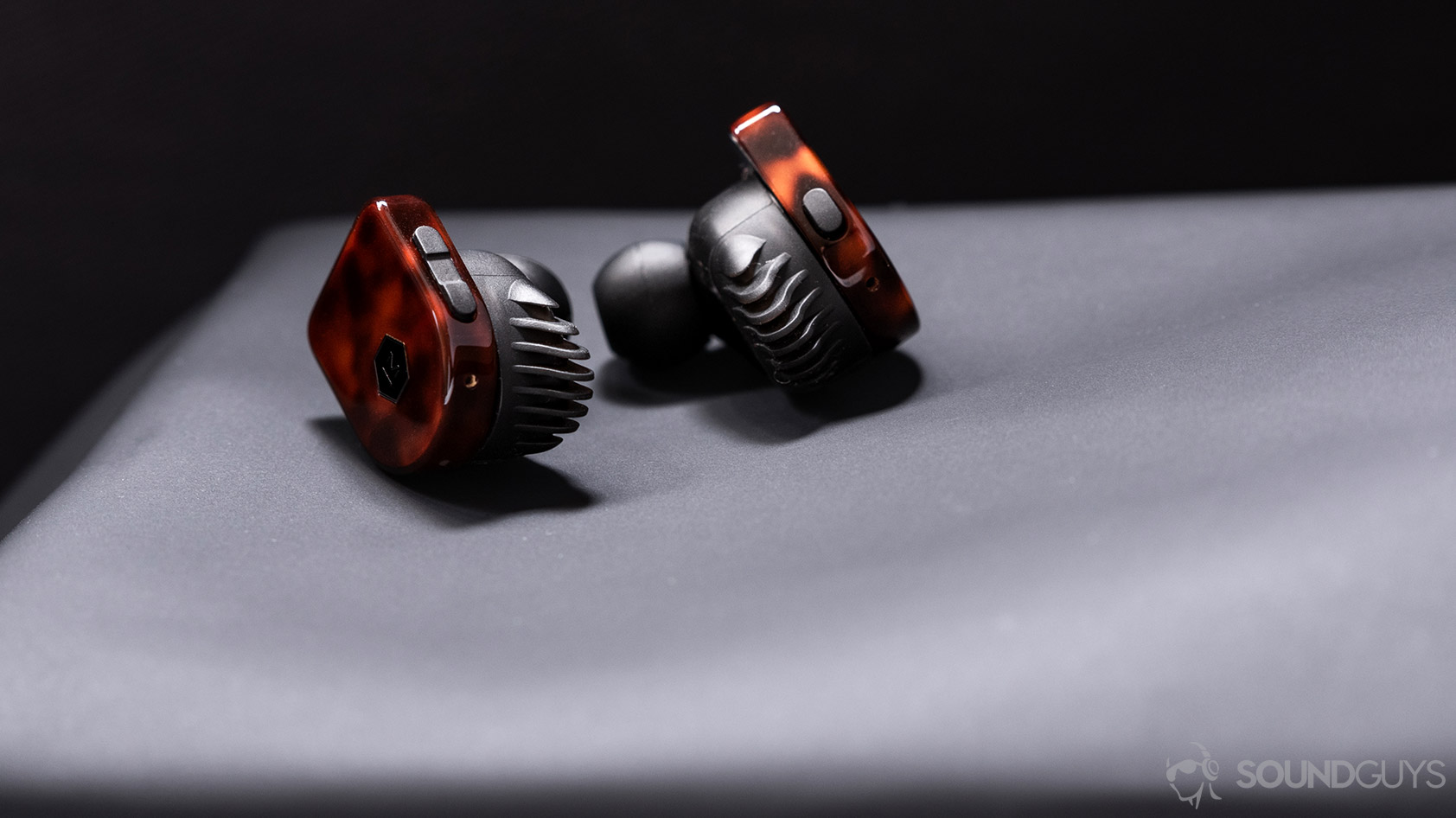 A picture of the Master &amp; Dynamic MW07 Plus noise canceling true wireless earbuds angled backward to display the on-board controls on each earbud.