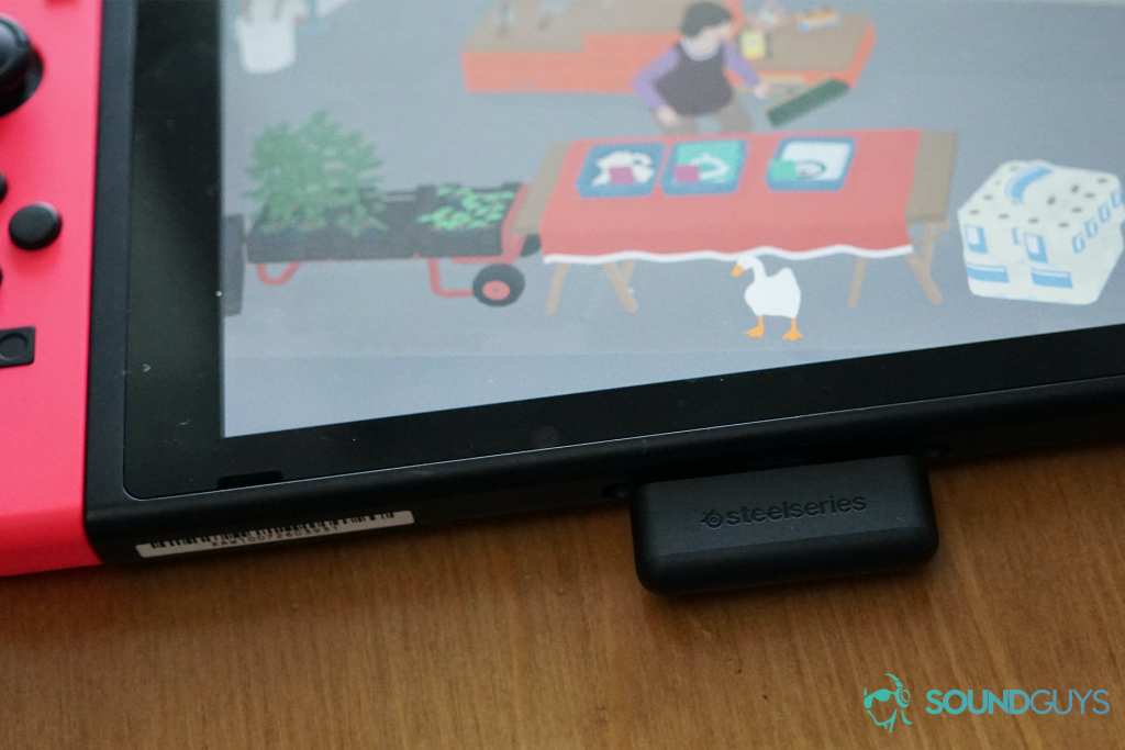 The SteelSeries Arctis 1 Wireless USB-C dongle plugged into the USB-C port of a Nintendo Switch running Untitled Goose Game.