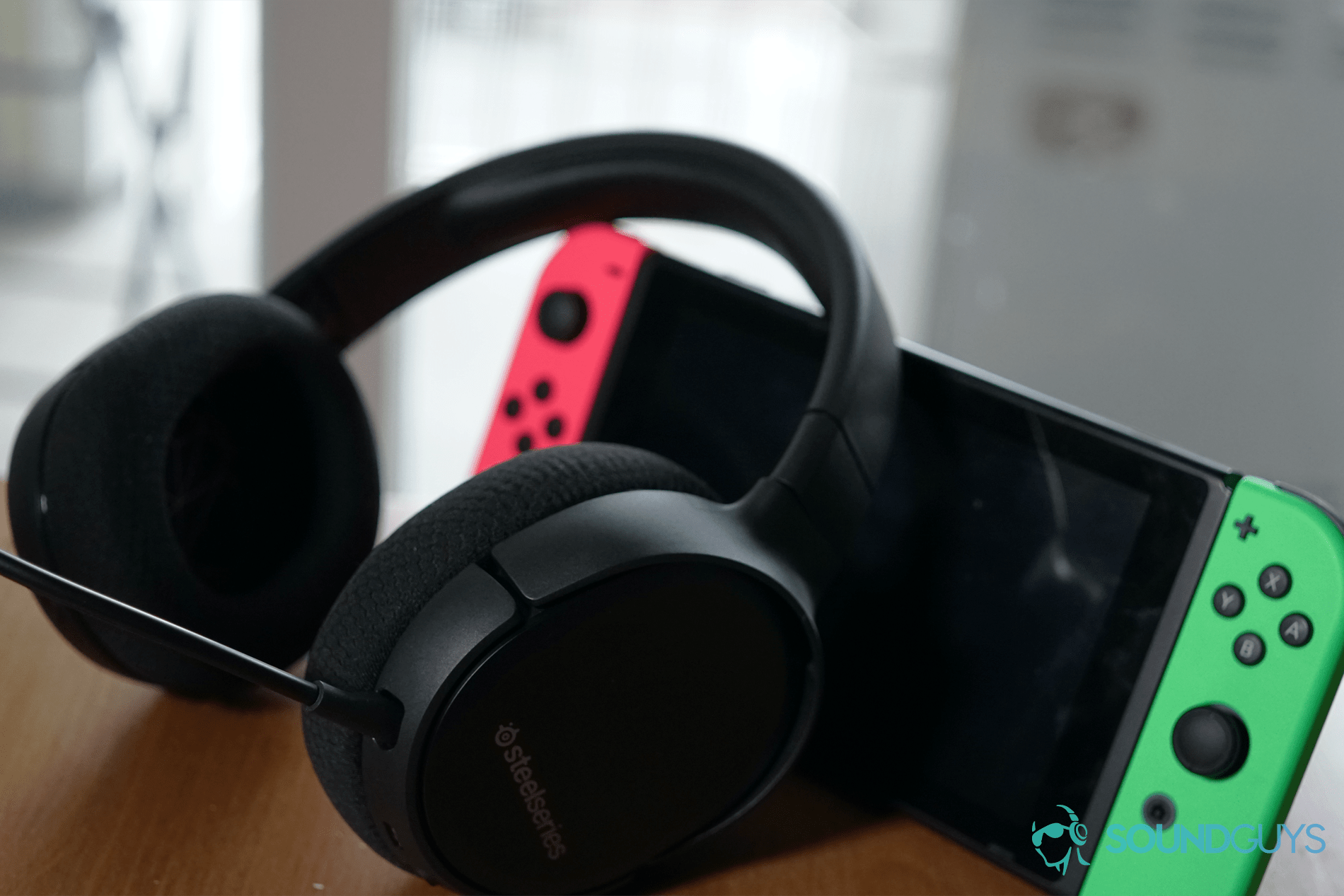 The SteelSeries Arctis 1 Wireless gaming headset on top of a Nintendo Switch.