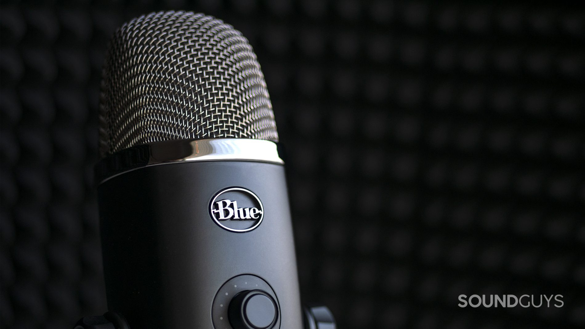 A photo of the Blue Microphones Yeti X in front of sound dampening material, a common mic choice for those wanting to podcast at home.