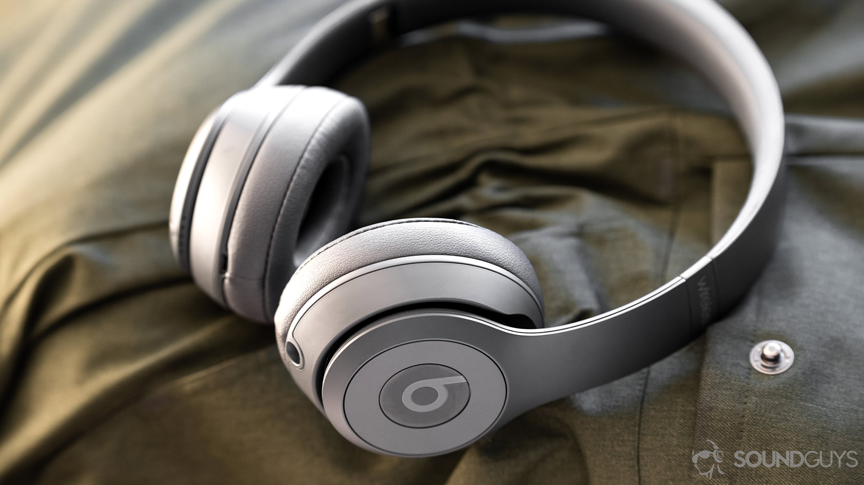 The Beats Solo3 Wireless in grey on a green cloth surface.