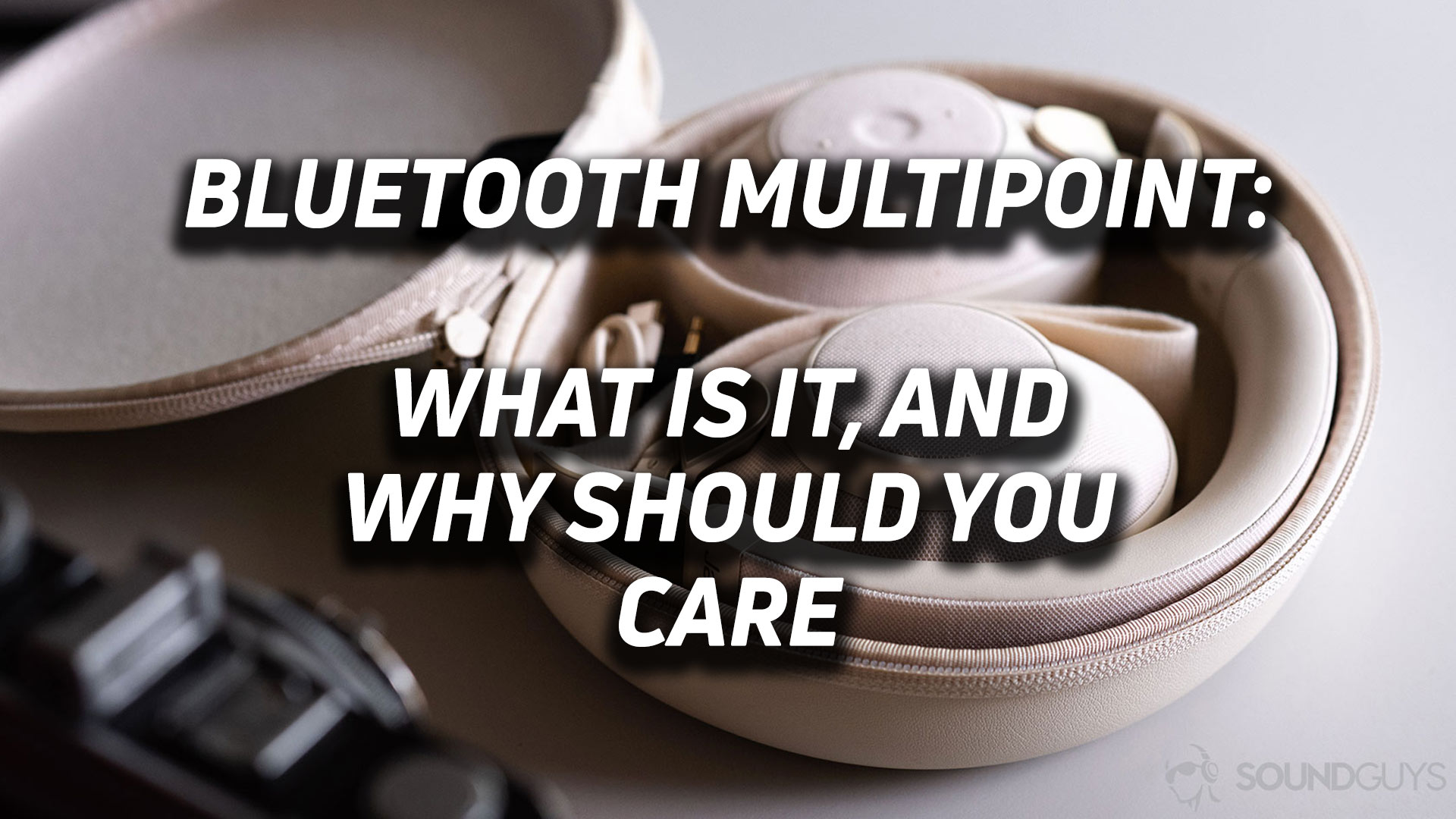 A picture of the Jabra Elite 85h headphones in beige with the text, "Bluetooth Multipoint: what is it, and why you should care" overlayed.
