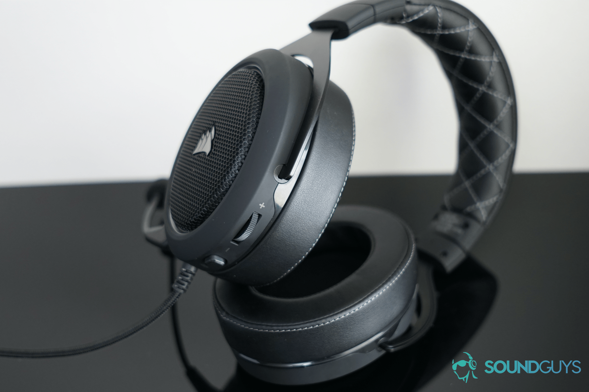 The corsair hs60 pro surround lies on its side with the on ear controls in view