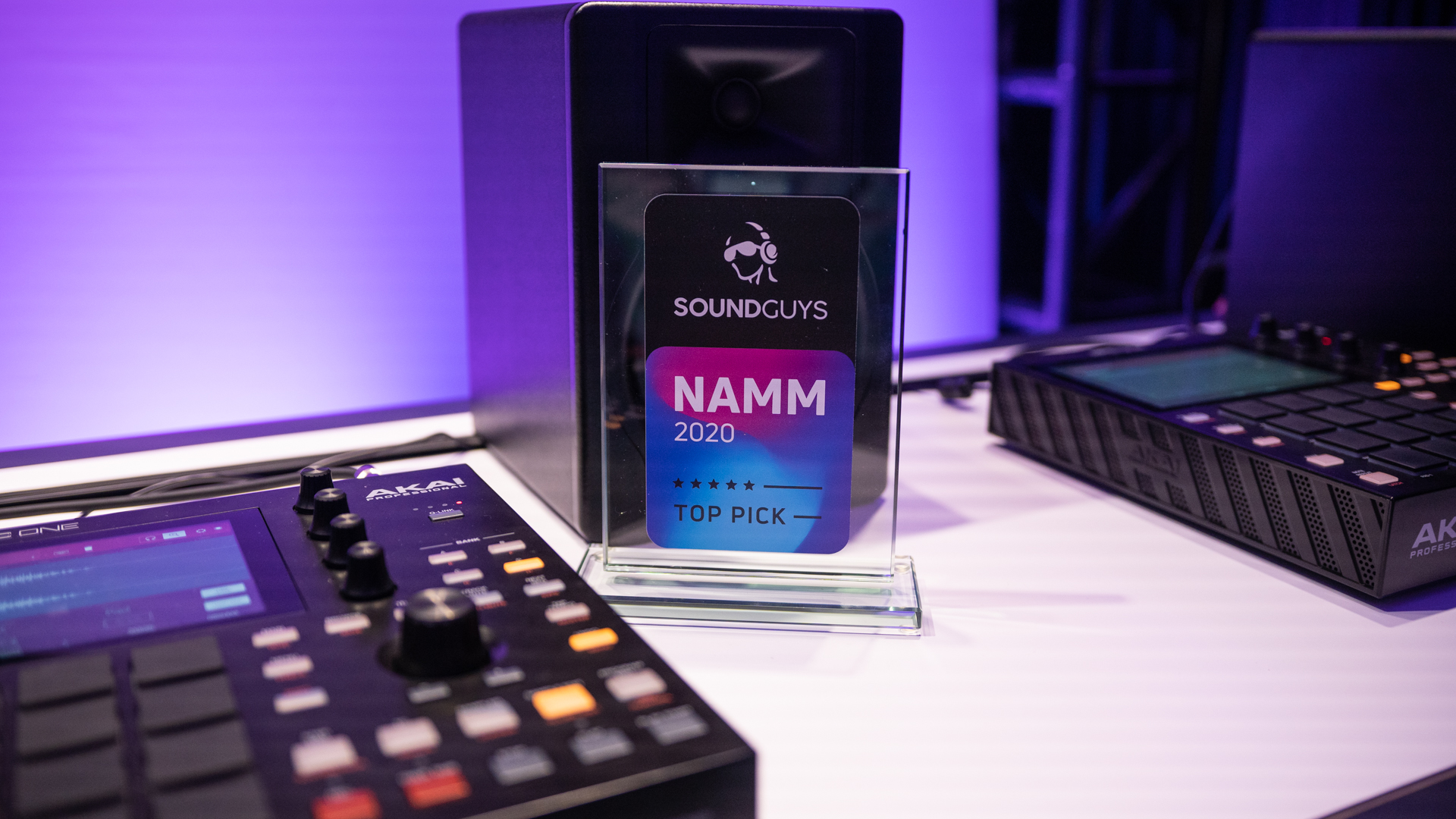 The new Akai MPC One pictured on a desk next to the best of NAMM 2020 SoundGuys award. 