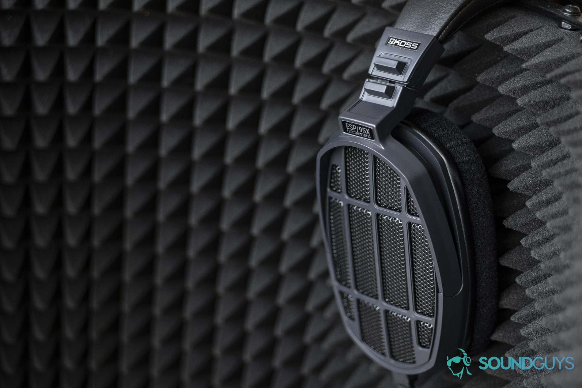 massdrop-koss-esp-95x-open-back-mic-shield A photo of the Massdrop x Koss ESP/95X electrostatic headphones, resting on a microphone shield.