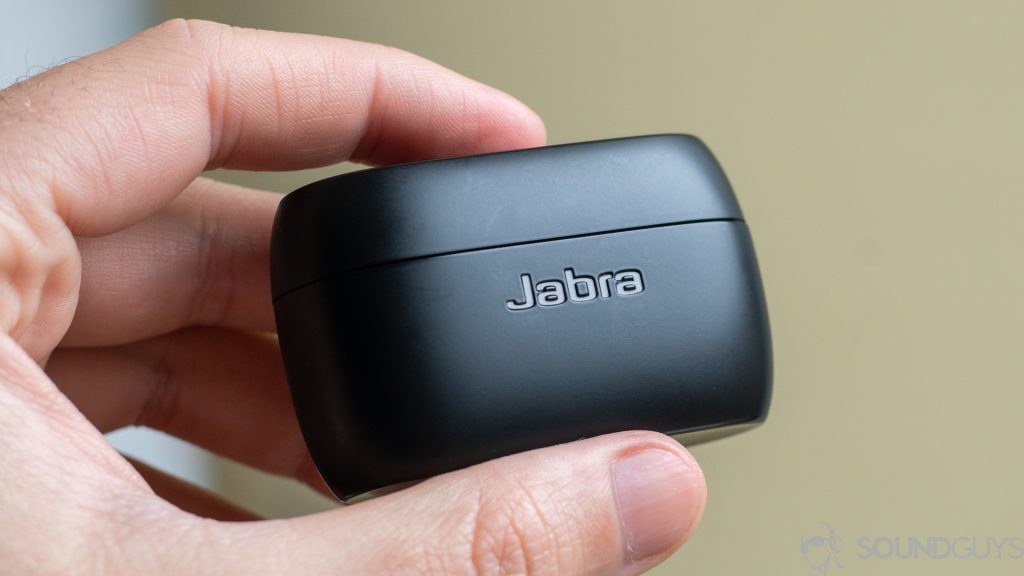 Man holding closed Jabra Elite 75t charging case