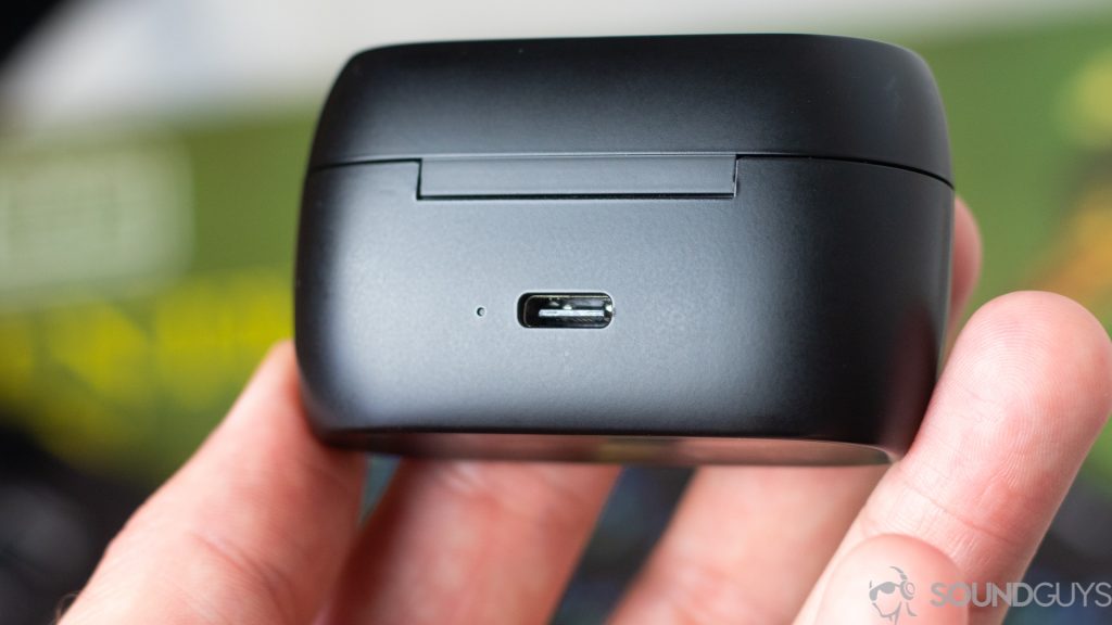 Man holding the Jabra Elite 75t charging case with close-up of the USB-C charging port.