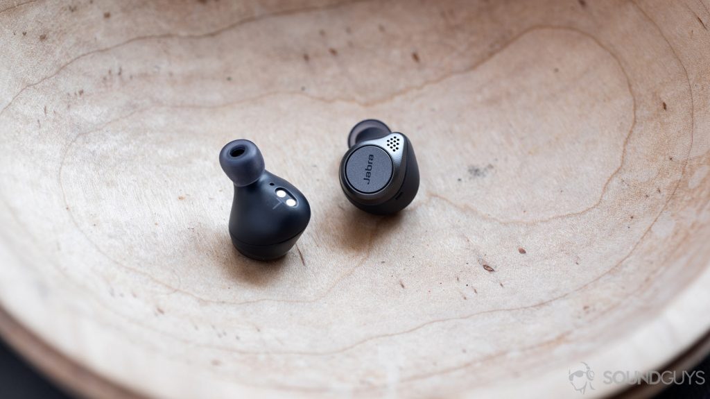 A picture of the Jabra Elite Active 75t true wireless workout earbuds in navy inside a wooden bowl.