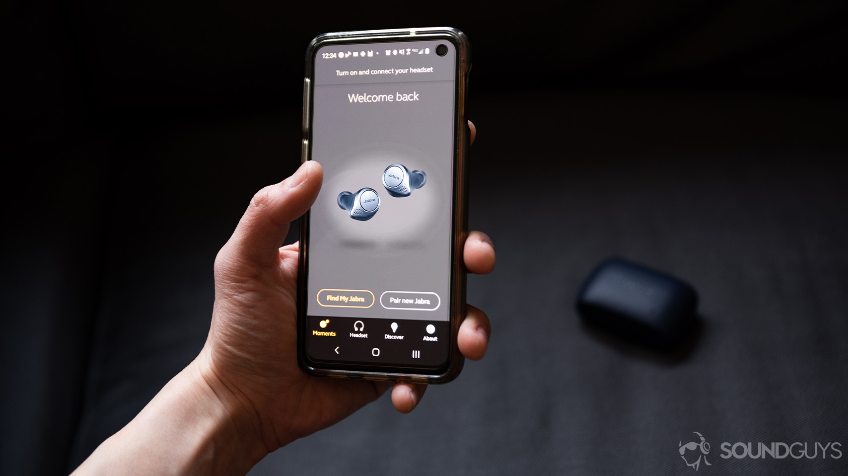 A picture of a hand holding a smartphone with the Jabra MySound+ app pulled up for the Jabra Elite Active 75t true wireless workout earbuds (navy).