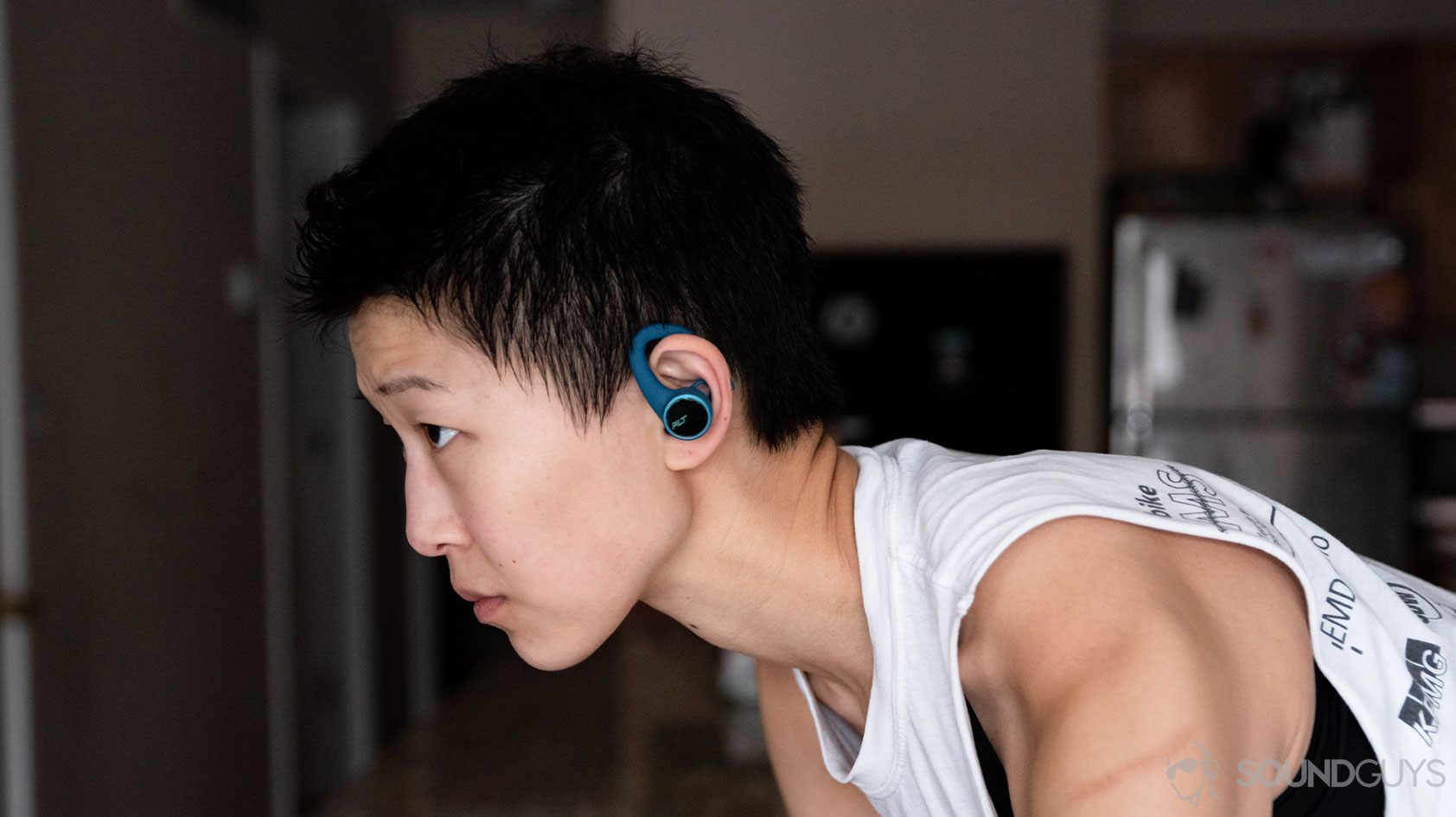A picture of the Plantronics BackBeat Fit 3200 true wireless workout earbuds worn by a woman on a bike in profile.