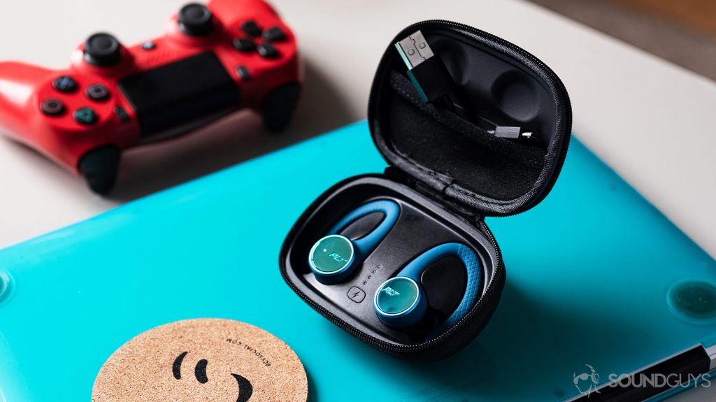 A picture of the Plantronics BackBeat Fit 3200 true wireless workout earbuds in the case which is angled up on a Macbook Pro laptop.