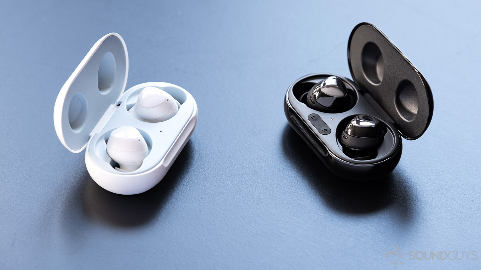 Samsung Galaxy Buds Plus-comparison versus true wireless charging cases 2 A comparison picture of the Samsung Galaxy Buds Plus and Galaxy Buds in their respective cases, angled toward each other; both headsets are more feature-dense than the Edifier TWS6.