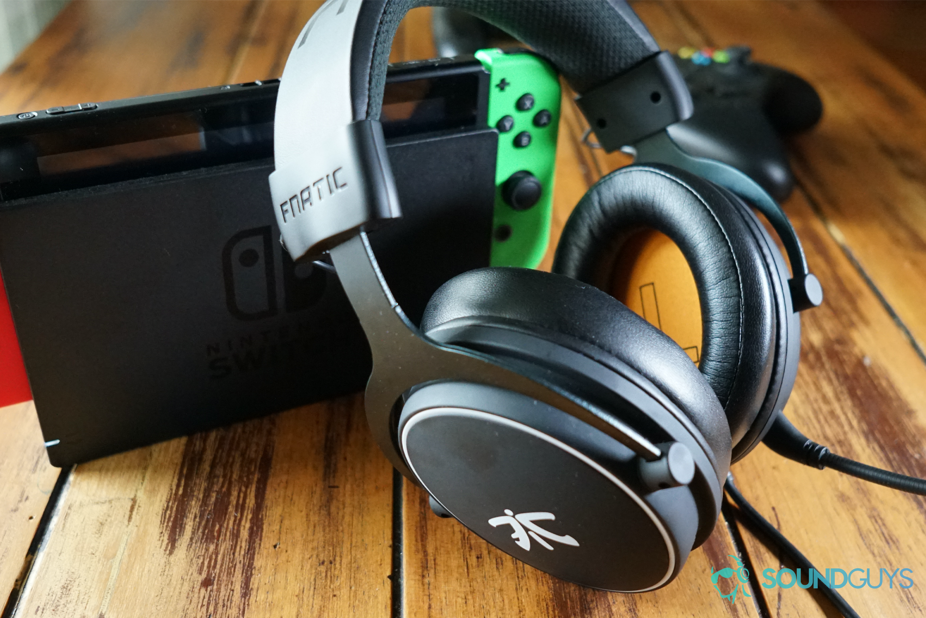 fnatic react switch shot The fnatic react headset sits on a wooden table, leaning on a docked Nintendo Switch, in front of an Xbox One question