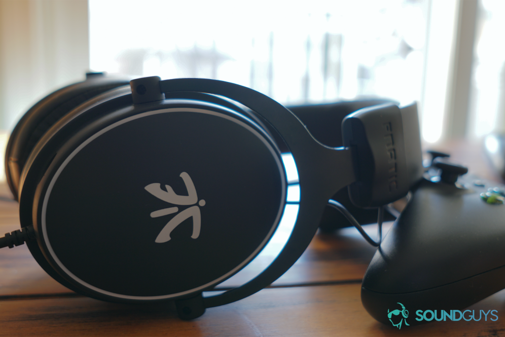 The fnatic react gaming headset leans on an Xbox One controller.