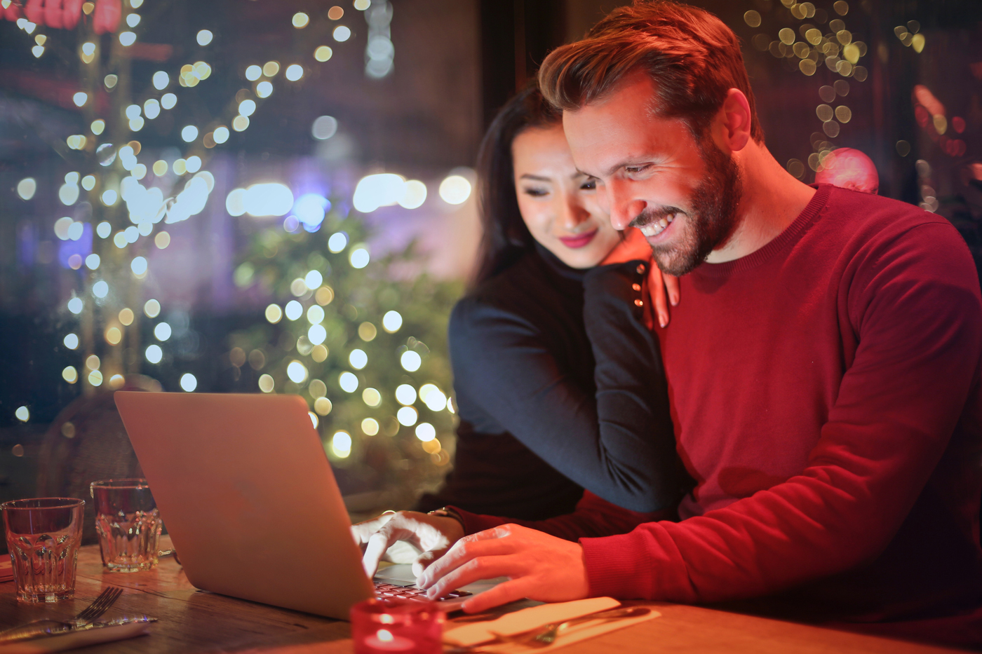 A photo of a man and woman shopping online.