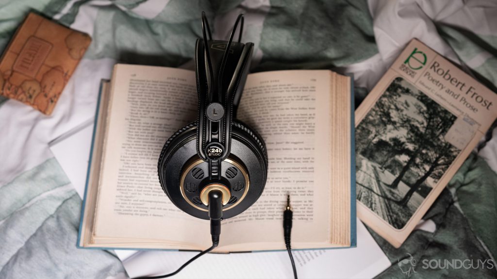 An aerial photo of the AKG K240 Studio semi-open headphones on an open book.