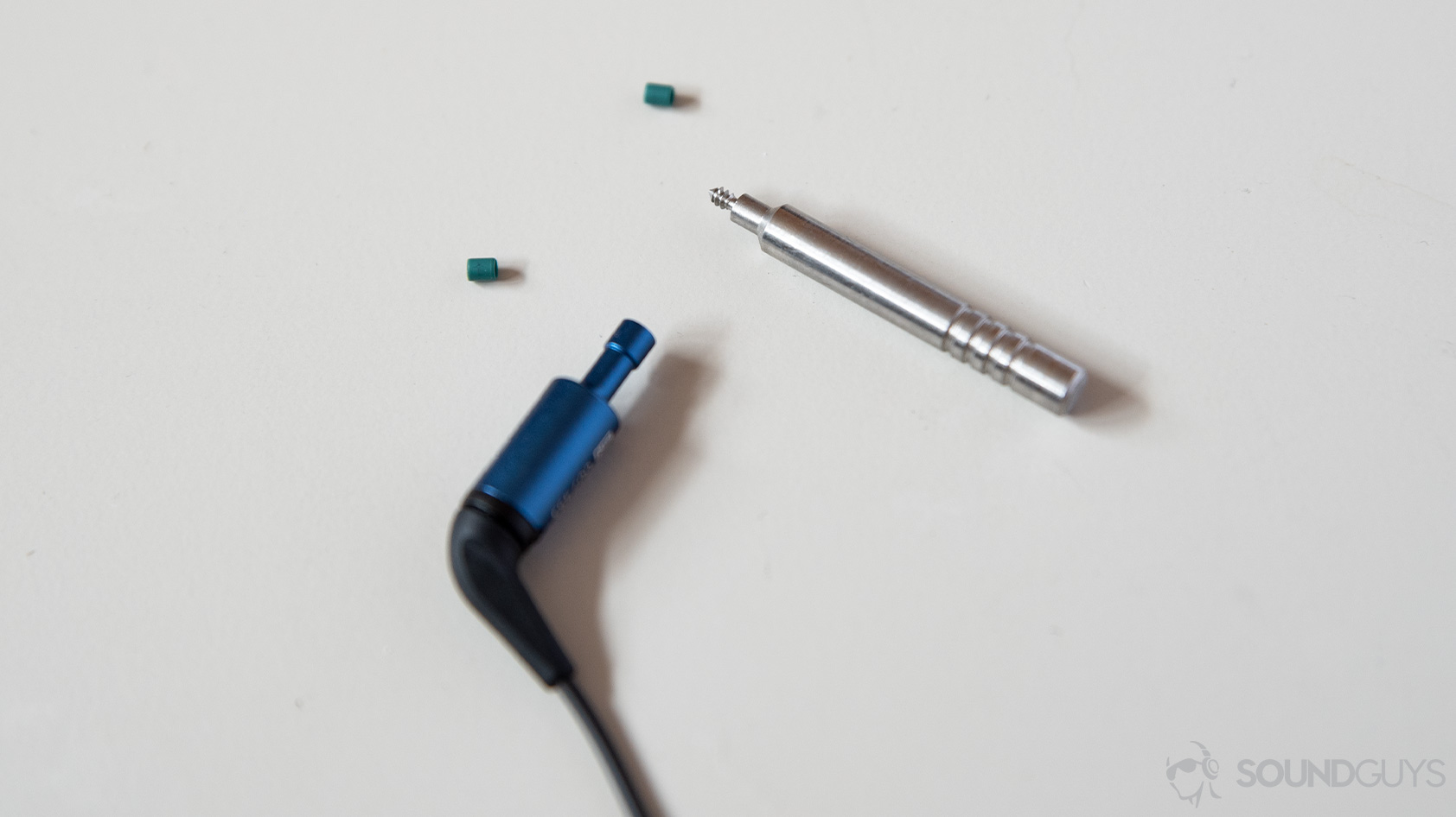 A picture of the Etymotic ER2SE wired earbuds and the filter removal tool.