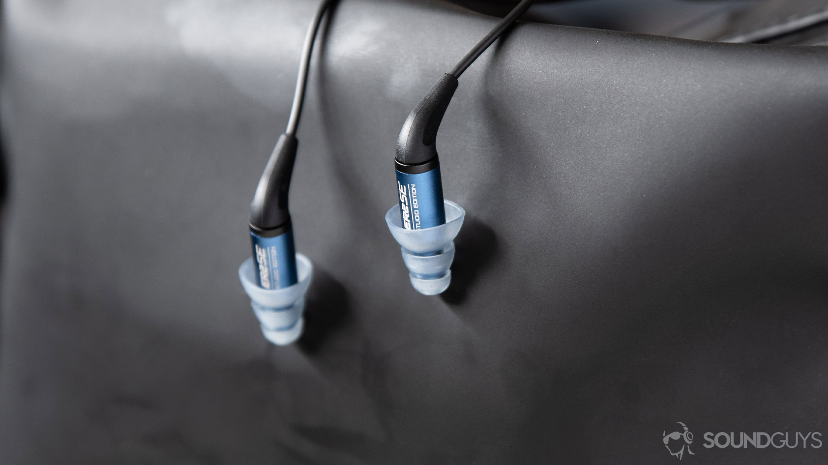 Tthe Etymotic ER2SE wired earbud housings in front of a matte-black backdrop.