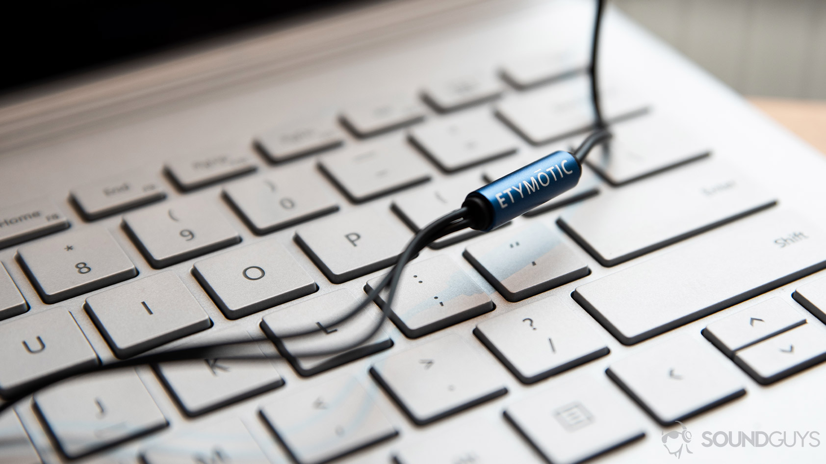 A picture of the Etymotic ER2SE wired earbuds' Y-splitter with the company logo.