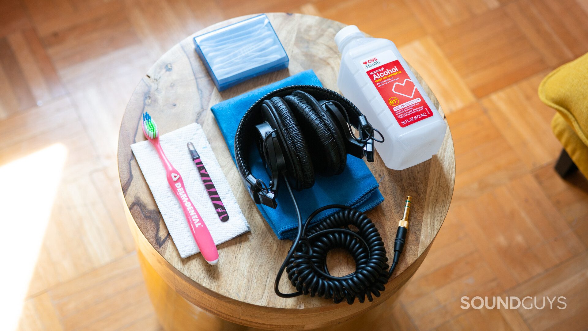 How to clean headphones-1 Sony headphones on a wooden stool with cleaning supplies in the sun