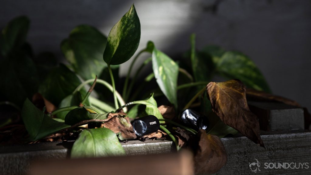 A photo of the LG Tone Free HBS FL7 true wireless earbuds on a plant holder.