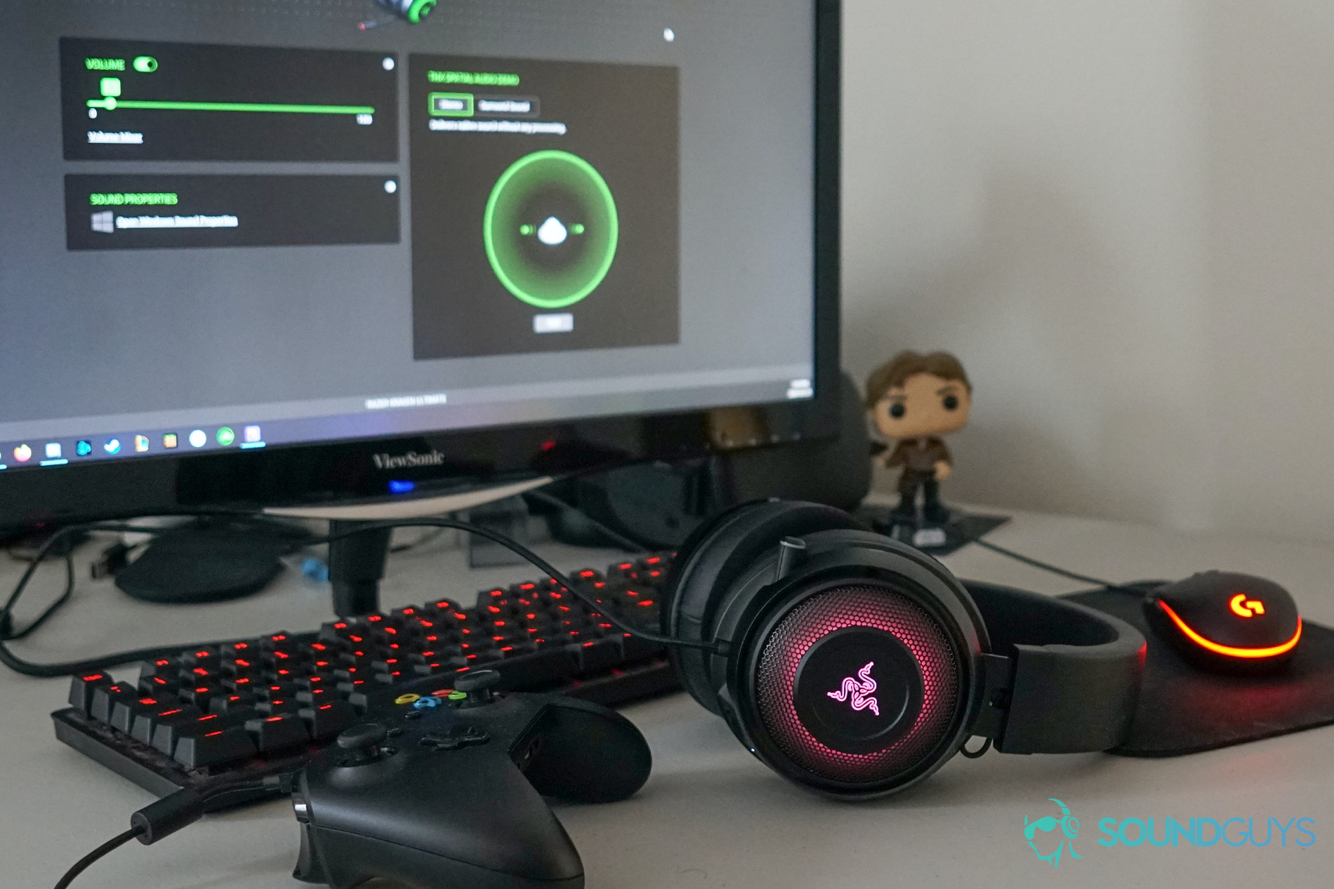A picture of the Razer Kraken Ultimate on a desktop with the monitor open to the Synapse software.