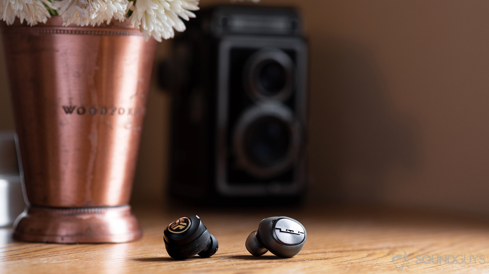 A photo of the Sol Republic Amps Air Plus true wireless noise canceling earbud compared to the JLab JBuds Air Icon.