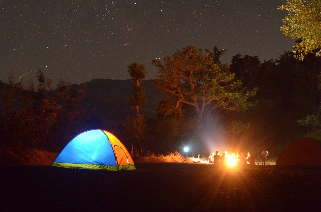 A photo of a bonfire party, a good place to start your search if you want to know how to find new music.