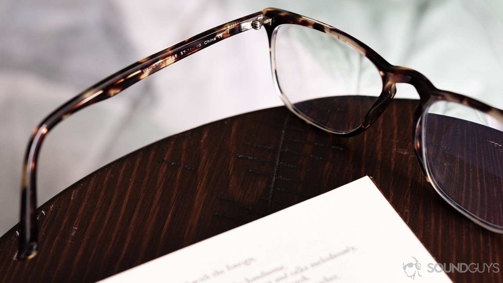 A picture of Warby Parker tortoise shell glasses with the arm in focus.