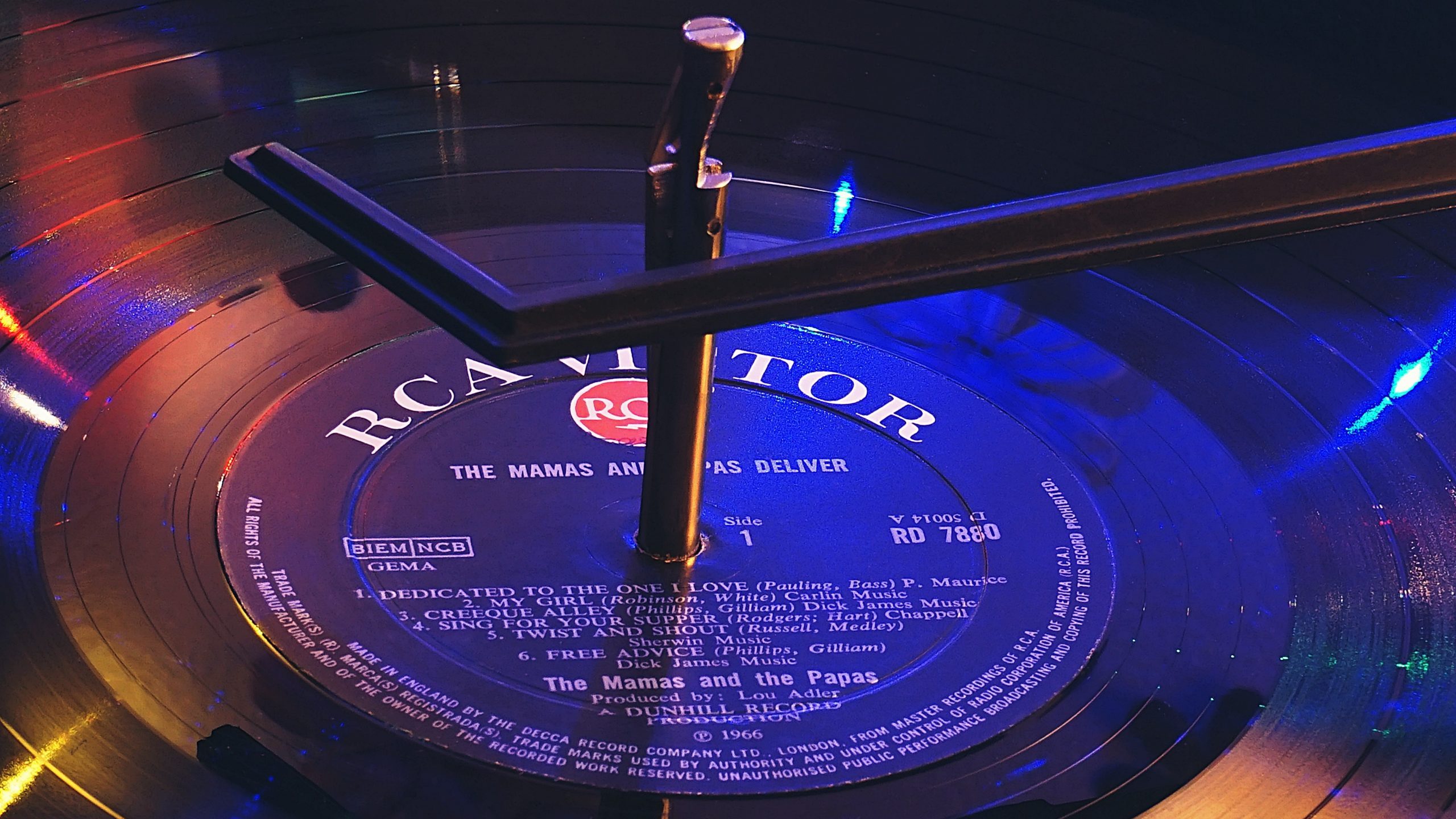 A photo of a vinyl record with a label and producer listed on the front; essential information for those looking how to find new music.