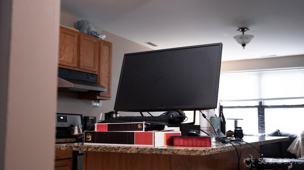 A picture of a desk setup on a kitchen counter with a monitor to show how to work from home with limited space.