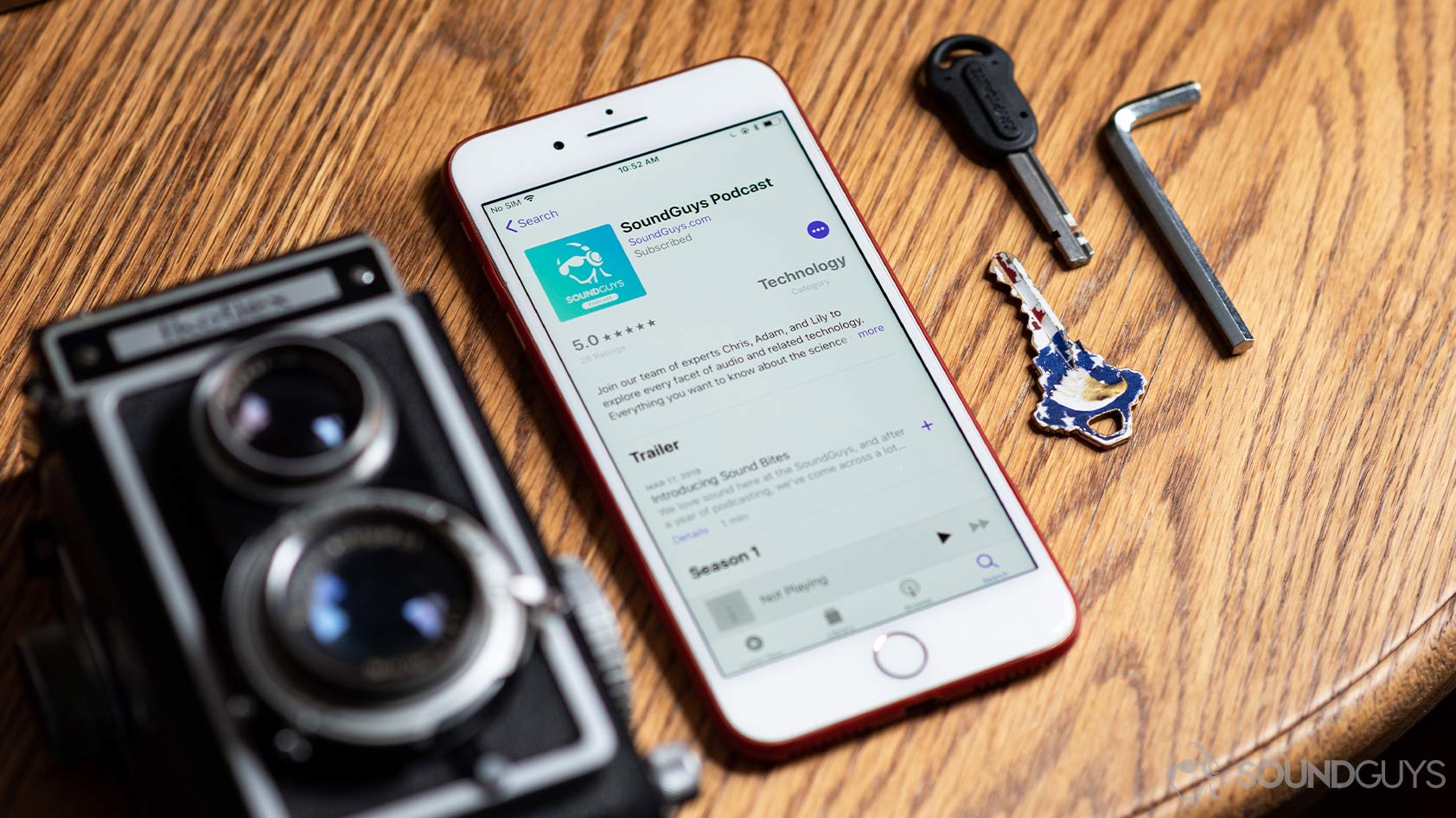 Apple Podcasts ratings-iPhone reviews The Apple Podcasts app open on an iPhone 8 Plus with the SoundGuys Podcast displaying a five-star review.