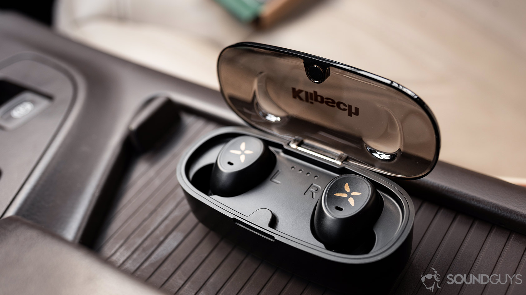 A picture of the Klipsch S1 True Wireless earbuds in the microUSB charging case with the lid flipped open.