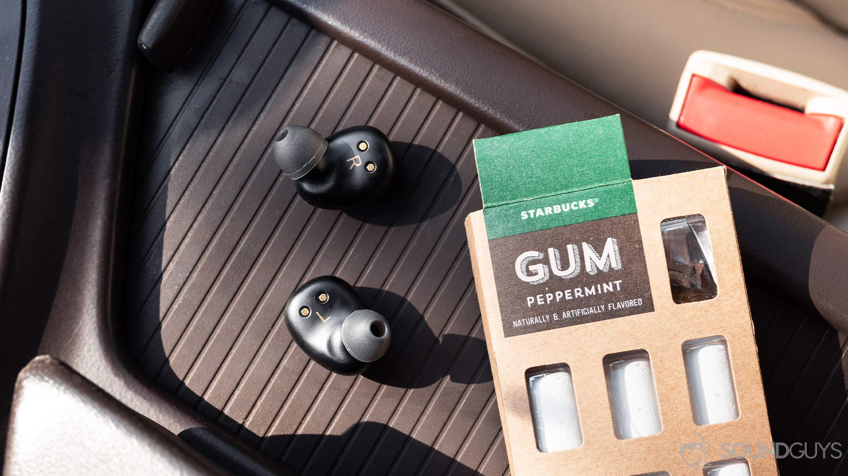 Klipsch S1 True wireless-earbuds connector pins An aerial picture of the Klipsch S1 True Wireless earbuds on the center console of a car.