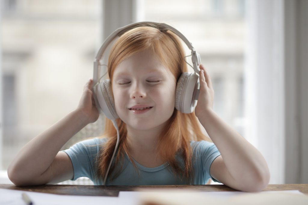 A child listening to headphones, used for illustrative effect when addressing how to find new music.