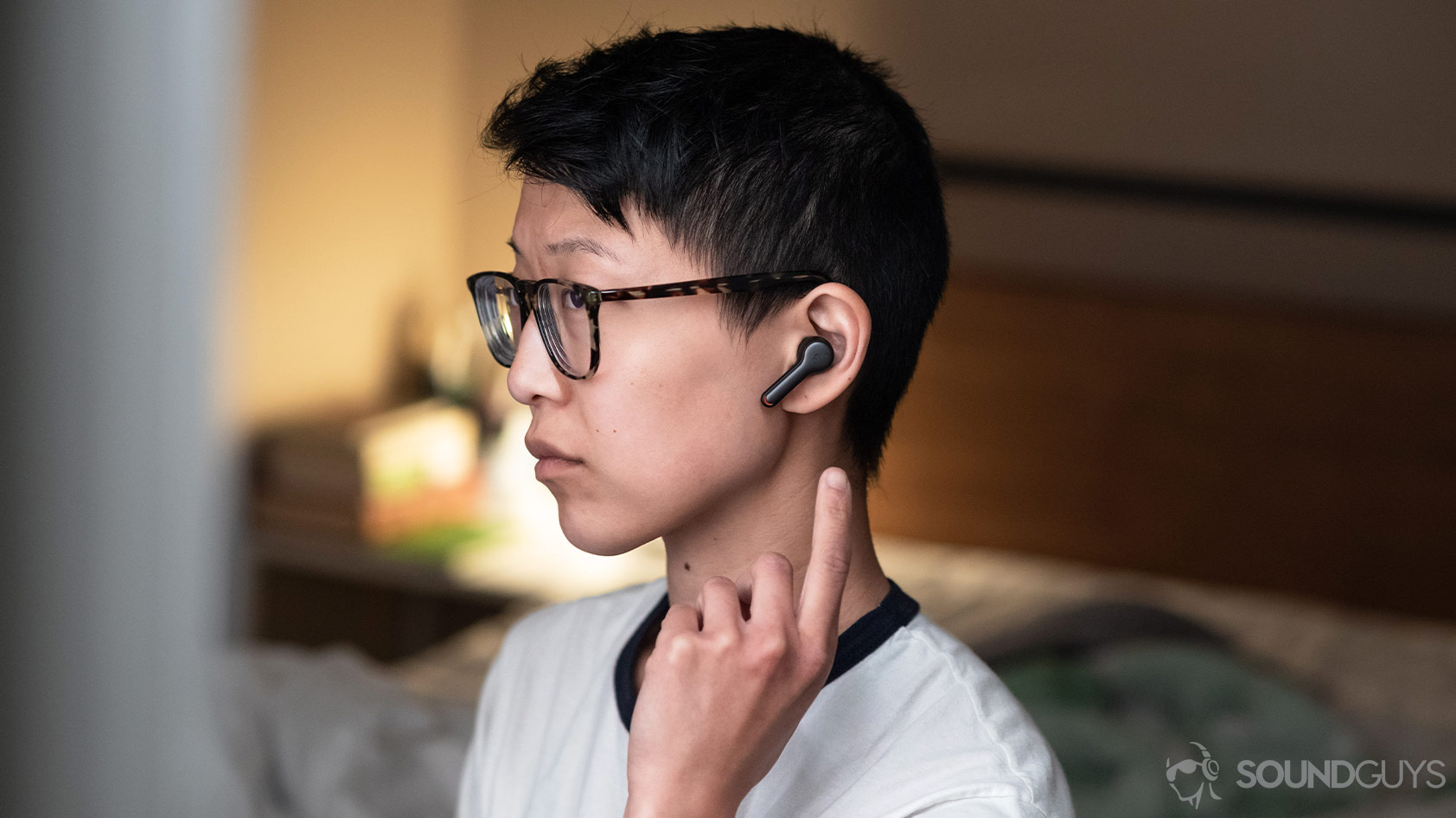 A photo of the Anker SoundCore Liberty Air 2, which is a better value than the Edifier TWS6, being worn and used by a woman in profile view.